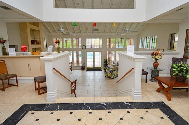 foyer featuring light tile patterned floors and a high ceiling