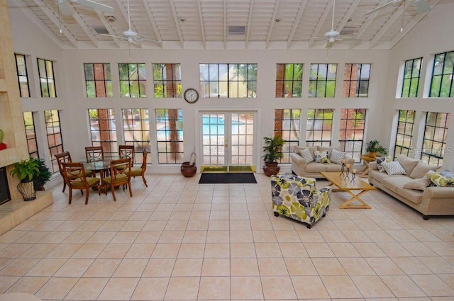 sunroom / solarium featuring french doors, lofted ceiling, and ceiling fan