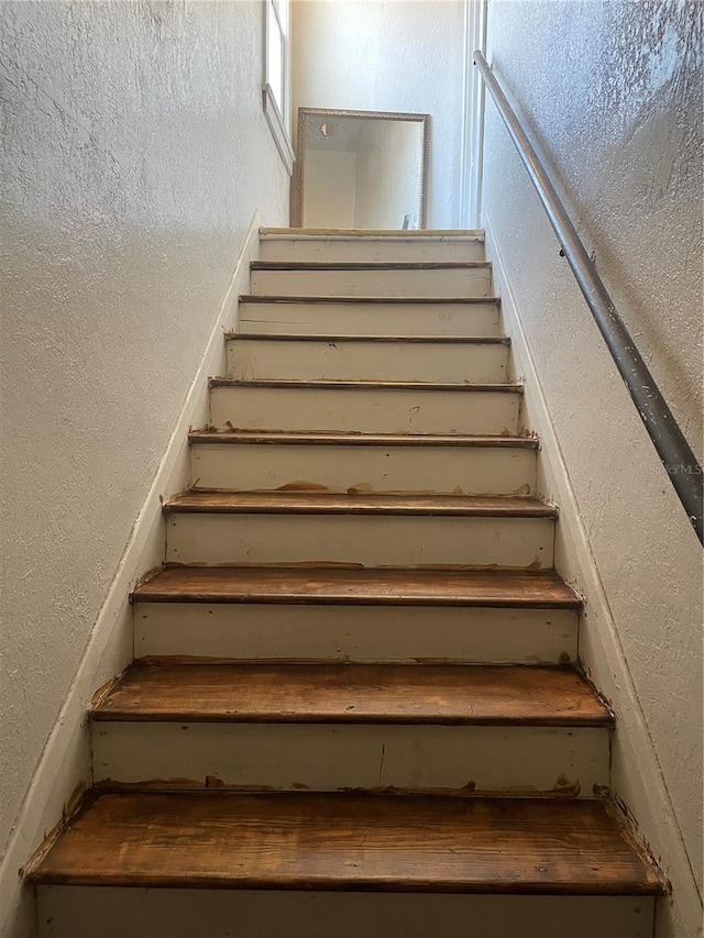 stairway with a textured wall