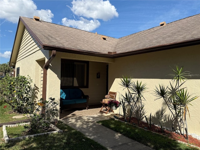 doorway to property featuring a patio and outdoor lounge area