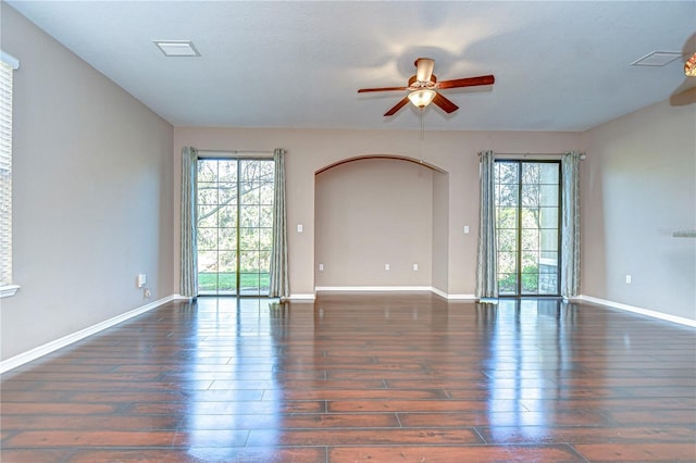 spare room with dark hardwood / wood-style flooring and ceiling fan