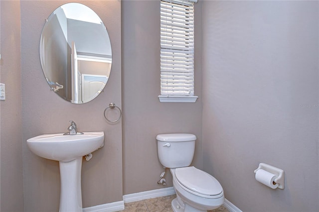 bathroom with toilet and tile patterned flooring