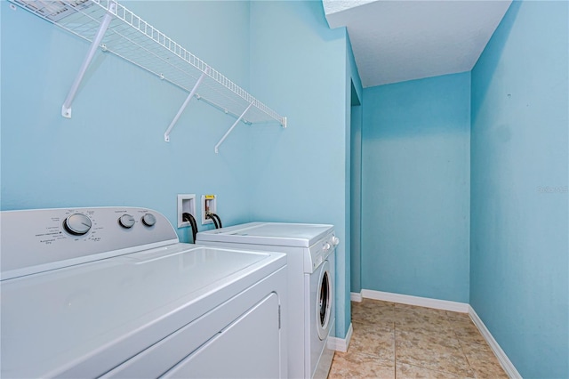 clothes washing area featuring washer and clothes dryer