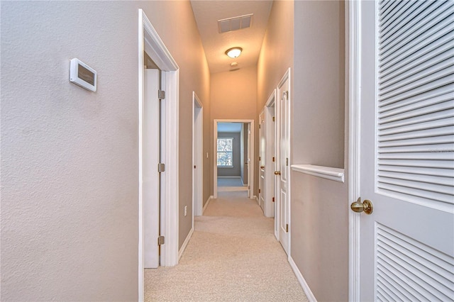 hallway featuring light carpet