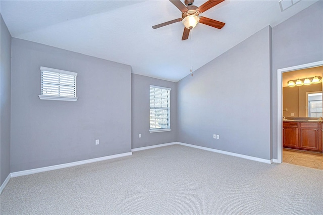 carpeted empty room featuring lofted ceiling and ceiling fan