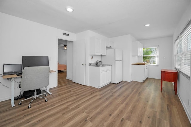 office featuring sink and light wood-type flooring