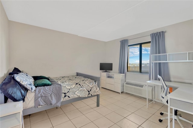 bedroom with light tile patterned floors and a wall unit AC