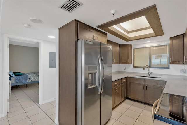 kitchen with visible vents, electric range, a sink, stainless steel fridge, and light tile patterned floors