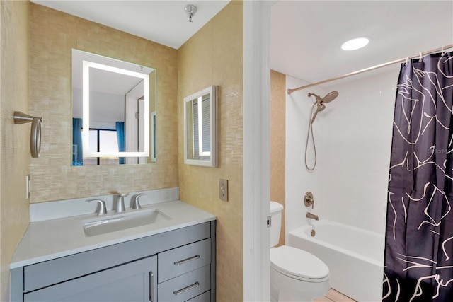 bathroom featuring toilet, shower / bath combo, and vanity