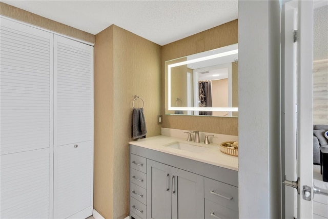 full bath with vanity and a closet