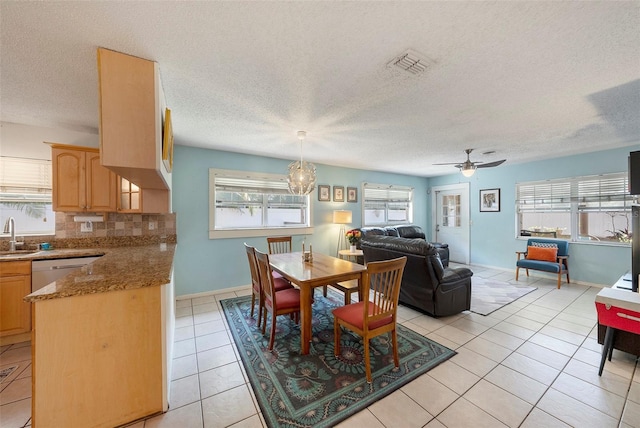 dining room featuring baseboards, visible vents, a textured ceiling, and light tile patterned flooring