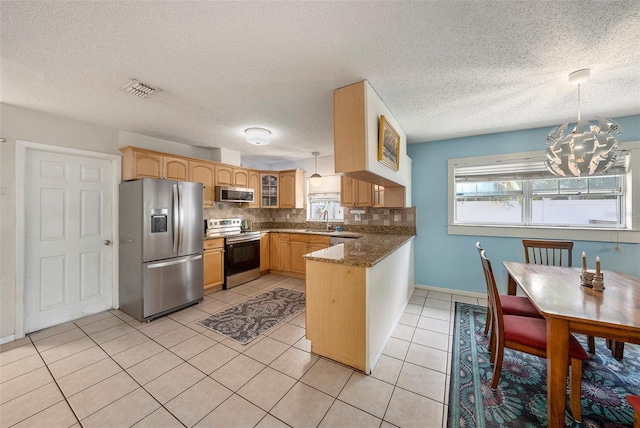 kitchen with decorative light fixtures, stainless steel appliances, visible vents, decorative backsplash, and glass insert cabinets