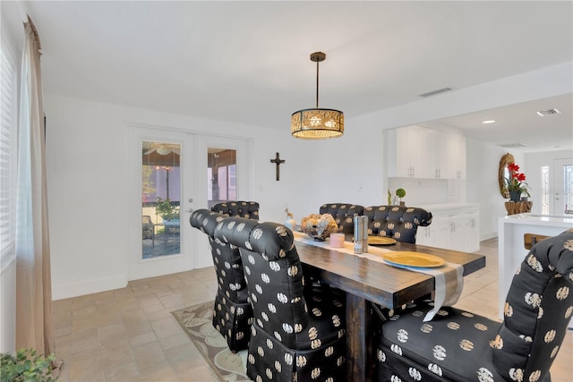 dining area with french doors, visible vents, and baseboards