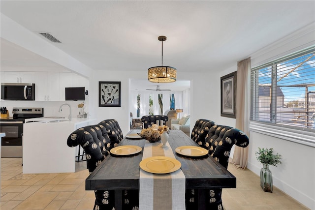 dining room featuring visible vents and baseboards