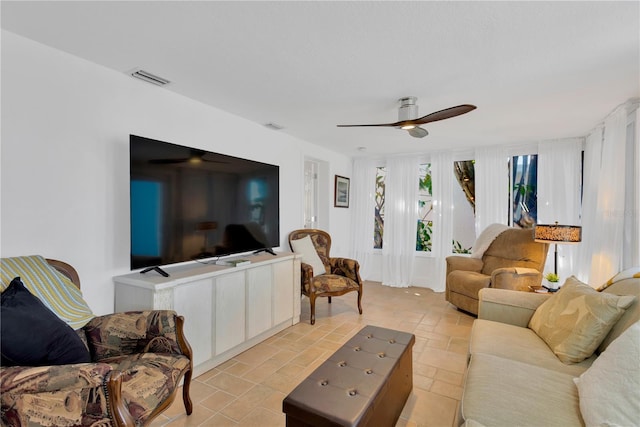 living area with visible vents and a ceiling fan