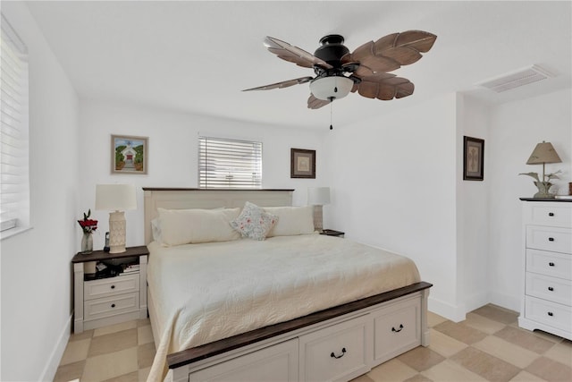 bedroom featuring visible vents, light floors, baseboards, and ceiling fan