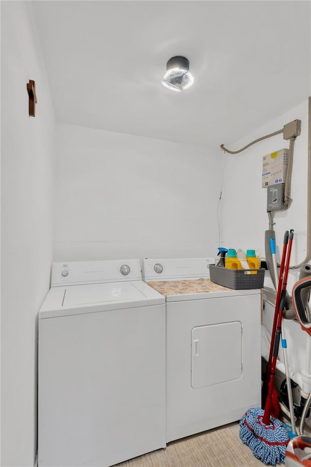 clothes washing area featuring laundry area and washing machine and clothes dryer