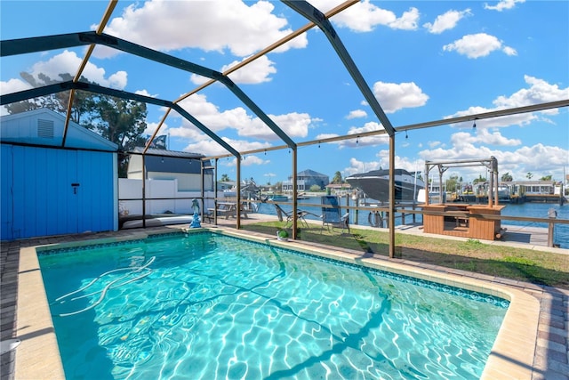 pool featuring a dock, a shed, glass enclosure, an outdoor structure, and boat lift