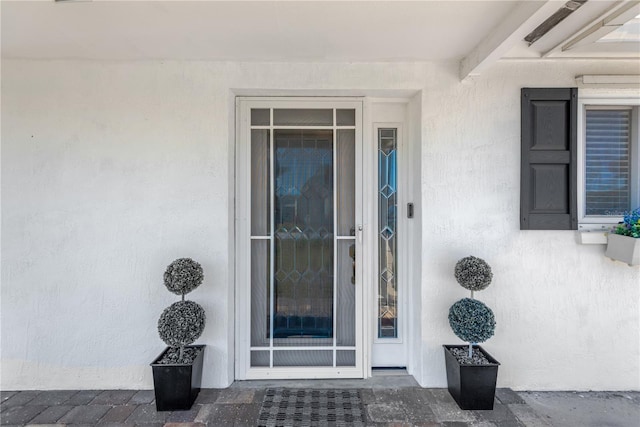 doorway to property with stucco siding