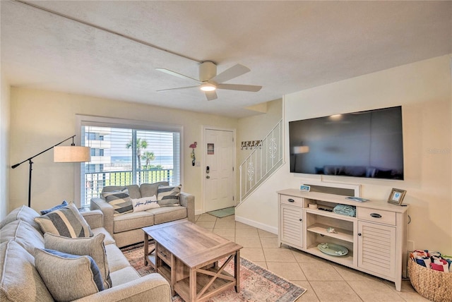 living room with ceiling fan and light tile patterned flooring