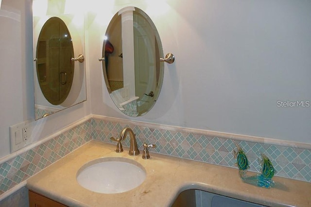 bathroom with a wainscoted wall and vanity