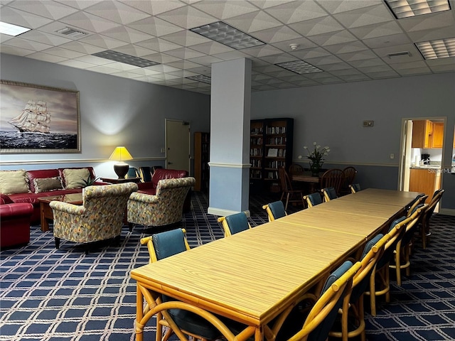 dining area with a drop ceiling, carpet, and visible vents