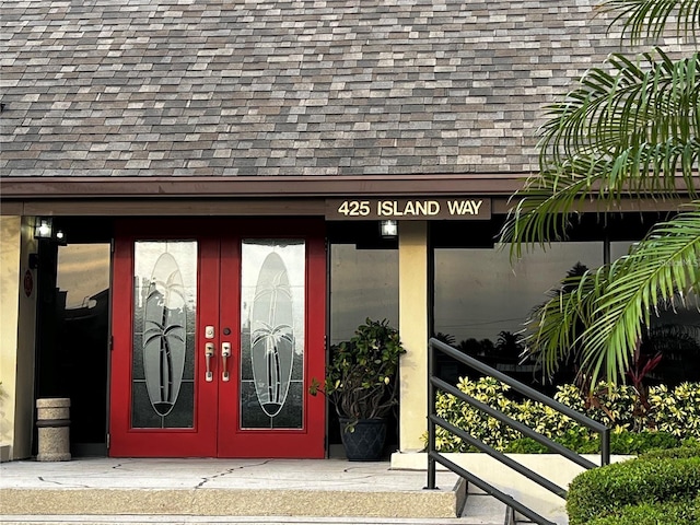 property entrance with a shingled roof