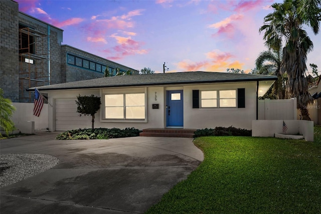 view of front of house with a yard and a garage