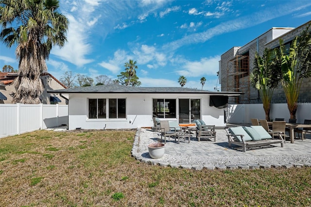 back of house featuring a yard and a patio