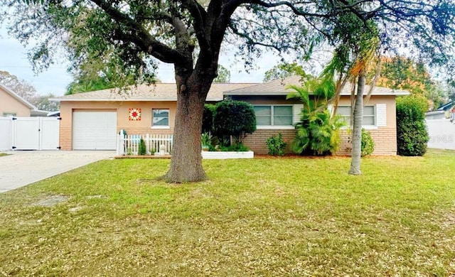 ranch-style house featuring driveway, an attached garage, a front lawn, and brick siding