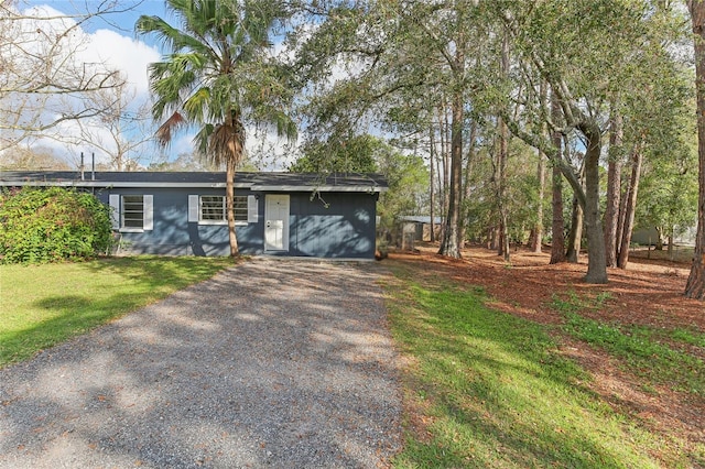 view of front of property with driveway and a front lawn