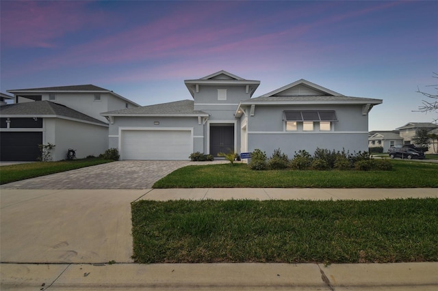 view of front of home featuring a yard and a garage