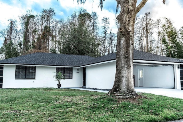 single story home with roof with shingles, a front yard, an attached garage, and stucco siding