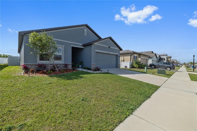 ranch-style house with a garage, concrete driveway, stone siding, fence, and a front yard