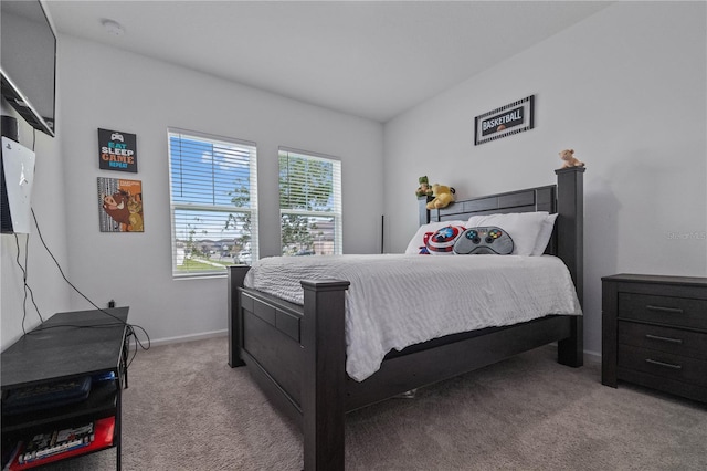 bedroom featuring light colored carpet and baseboards