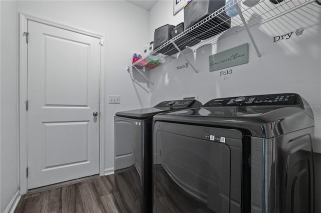 washroom featuring laundry area, independent washer and dryer, dark wood finished floors, and baseboards