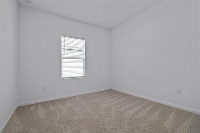 unfurnished room featuring carpet flooring and baseboards