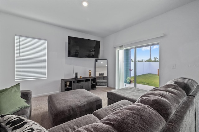 carpeted living area featuring baseboards