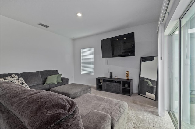 living room featuring light colored carpet and visible vents