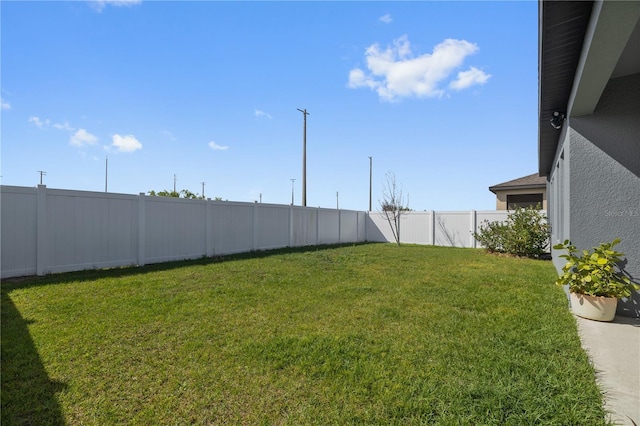 view of yard with a fenced backyard