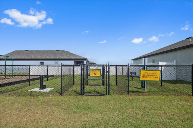 view of yard featuring fence and a gate