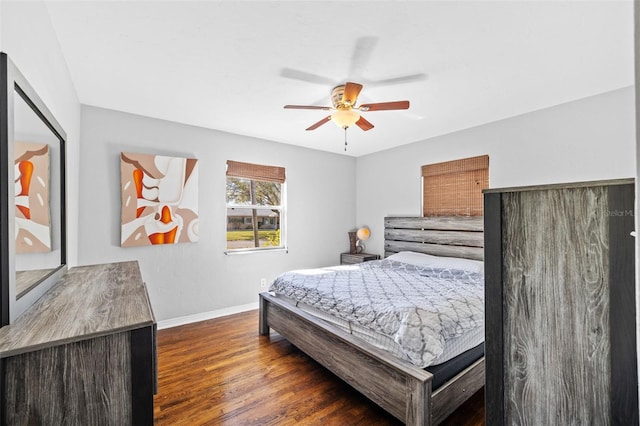 bedroom with a ceiling fan, baseboards, and wood finished floors