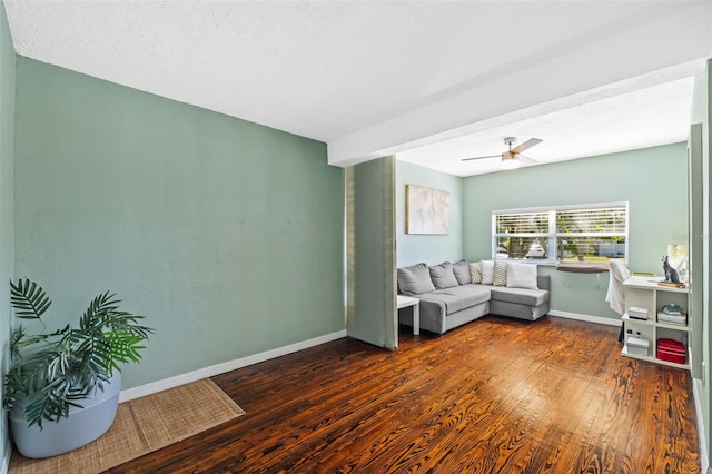 living area featuring hardwood / wood-style flooring, baseboards, and ceiling fan