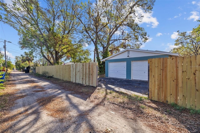 detached garage featuring fence