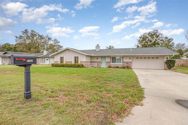 single story home featuring an attached garage, a front lawn, concrete driveway, and brick siding