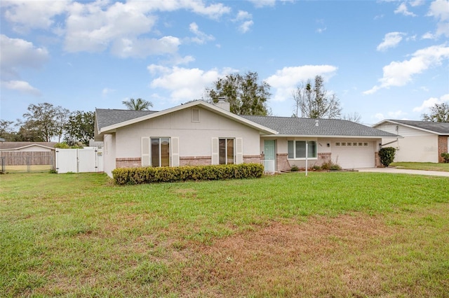 single story home with a garage, brick siding, driveway, and a front lawn