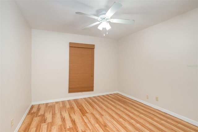 unfurnished room featuring ceiling fan, light wood-style flooring, and baseboards