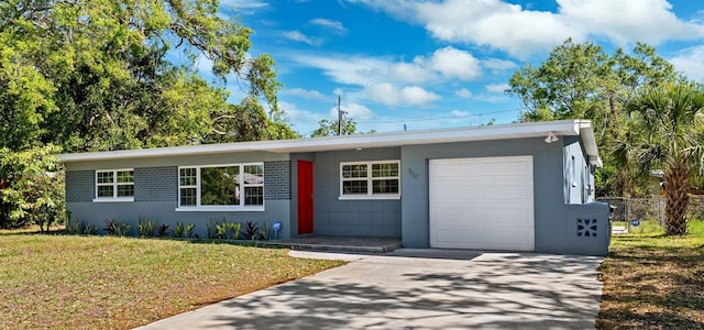 1119 77th St N, Saint Petersburg, FL 33710 - ranch-style home with stucco siding, a front lawn, fence, concrete driveway, and an attached garage