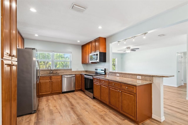 1119 77th St N, Saint Petersburg, FL 33710 - kitchen with a sink, visible vents, brown cabinets, and appliances with stainless steel finishes