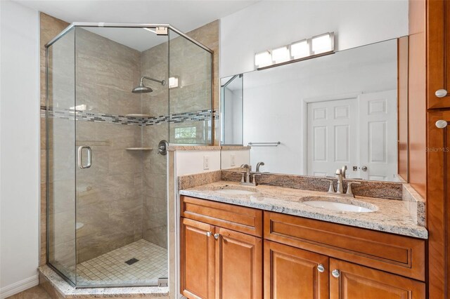 1119 77th St N, Saint Petersburg, FL 33710 - bathroom with double vanity, a stall shower, and a sink